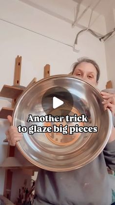 a woman holding a large metal bowl with the words another trick to glaze big pieces