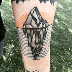 a person with a tattoo on their leg that has an iceberg in the middle