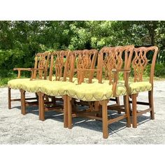 a set of eight wooden dining chairs with upholstered seats