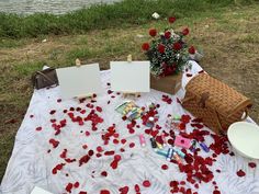 a table with rose petals and cards on it