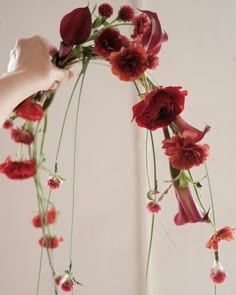 a person is arranging flowers in a vase