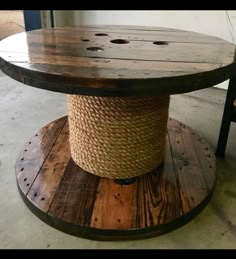 a round wooden table with rope on top