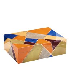 an orange, yellow and blue box with geometric designs on the lid is sitting in front of a white background