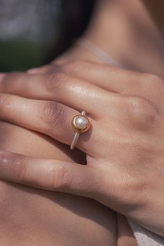 The gold plated Pearl Ring made from Sterling Silver is part of the Pearl Classics and symbolizes the natural beauty and high quality designs of Monika Herré.   The delicate ring band smoothly glides around the finger and is worked into the matt gold plated frame with precision. Monika Herré's characteristic combination of silver and gold brings out the glowing spark of the natural saltwater pearl. The ring can be wonderfully combined with any of the other pieces from the Pearl Classics. It took Modern Pearl Ring, Jewelry Mixed Metals, Ring Pearl Modern, Pearl Ring Design, Gold Bad, Pearl Wedding Ring, Pearl Rings, La Forge, Saltwater Pearls