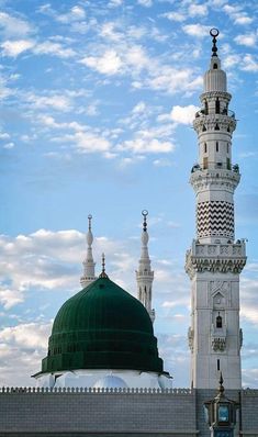 a tall white building with a green dome