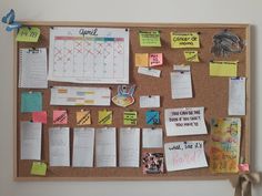 a bulletin board covered in sticky notes and magnets