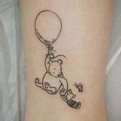 a small tattoo of a teddy bear holding a balloon