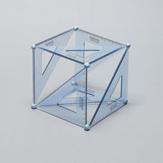 a clear cube with blue lines and arrows on the sides, in front of a white background