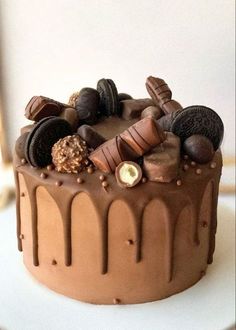 a cake with chocolate frosting and cookies on top