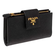 The Prada Saffiano Leather Long Wallet in black is a quintessential accessory that epitomizes luxury and sophistication. Crafted from the brand's signature Saffiano leather, this wallet boasts a distinctive crosshatch texture that not only adds visual appeal but also enhances durability. With its sleek, elongated design, this wallet offers ample space for your essentials. Inside, you'll find multiple card slots, a spacious bill compartment, and a zippered pocket for coins, all thoughtfully organ Leather Long Wallet, Prada Saffiano, Gold Interior, Long Wallet, Handbag Accessories, Cloth Bags, Black And Gold, Card Slots, Slots