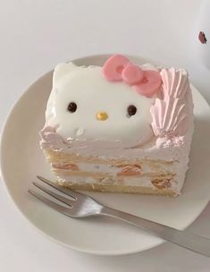 a hello kitty cake on a plate with a fork