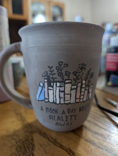 a coffee cup sitting on top of a wooden table