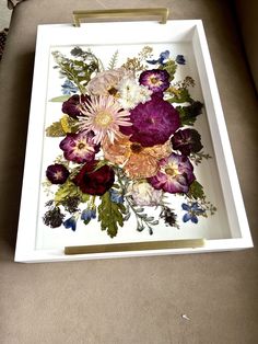 a white tray with flowers painted on it