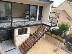 an aerial view of a house with stairs leading up to the second floor