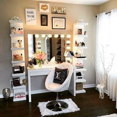 a room with a vanity, mirror and lights on the wall next to a window