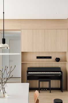 a living room filled with furniture and a piano in front of a wall mounted shelf