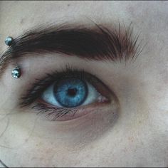 an eye with piercings on it