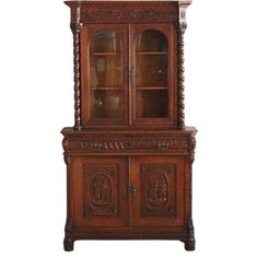 an old wooden cabinet with glass doors and carvings on the front, sitting against a white background