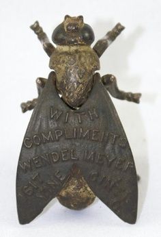 a bronze statue of a frog with words on it's back