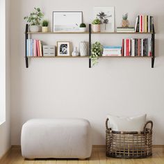 a living room with bookshelves and shelves on the wall, along with a footstool