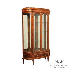 a wooden china cabinet with glass doors and drawers on the front, in an antique style