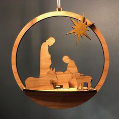 a wooden ornament with a nativity scene in the shape of a star