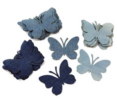 six butterfly shaped appliques in various colors and sizes on a white background with clippings attached to them