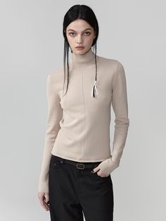 Soft texture viscose blend sheer turtleneck knit. Slim silhouette that naturally defines the body line - Clean point detail with a center line knit- Natural bottom hemming for a relaxed mood- Neckline adorned with a gold logo for added detail Sheer Knit Top, Sheer Turtleneck, Center Line, Sheer Knit, Sand Beige, Gold Logo, Soft Texture, Knit Top, Knitwear