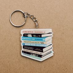 a stack of books keychain sitting on top of a table