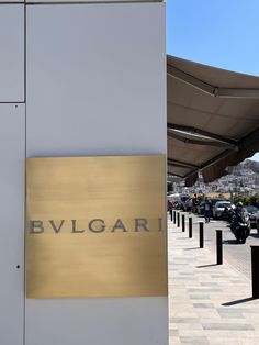 a sign on the side of a building that says bvlgari in gold