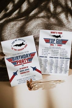 two birthday party flyers sitting on top of a table