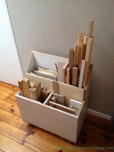 a stack of wooden blocks sitting on top of a hard wood floor next to a wall