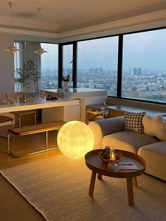 a living room filled with furniture and large windows