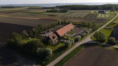 an aerial view of a farm house in the country side