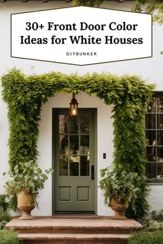 a white house with green plants growing over the front door