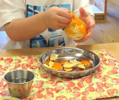 a young boy is eating an open sandwich in front of his bowl on the table