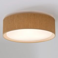 a round light fixture with woven fabric on the top and bottom, hanging from a ceiling