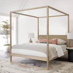 a bedroom with a canopy bed and rugs on the floor in front of it