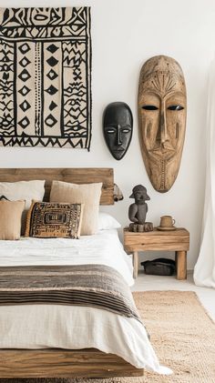 a bedroom with two african masks on the wall