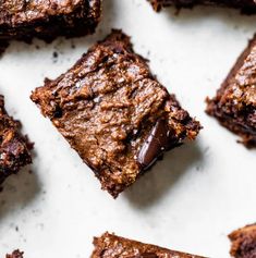 chocolate brownies cut into squares on a white surface