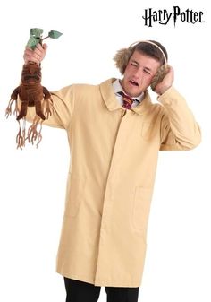 a man in a harry potter costume is holding an owl and talking on the phone