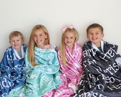 three young children wrapped in towels sitting next to each other