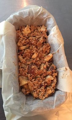 a close up of food in a paper bag on a table with a light behind it