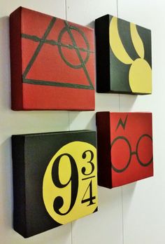 three harry potter house numbers are hanging on the wall in front of a white wall