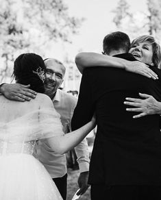 black and white photograph of bride hugging groom