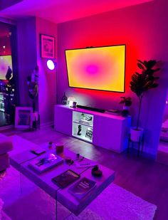 a living room filled with furniture and a large flat screen tv mounted on the wall