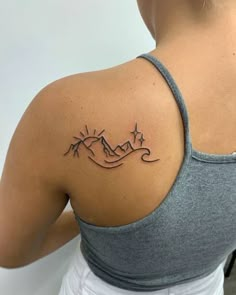 a woman with a tattoo on her shoulder