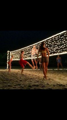 people are playing volleyball on the beach at night with lights in the background and text that reads best healthy pins