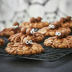 cookies with eyes and googly eyes are on a cooling rack, ready to be eaten