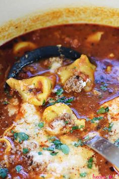 a bowl filled with pasta and meat soup